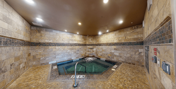 Indoor spa with cascading waterfall, steam room and cedar sauna